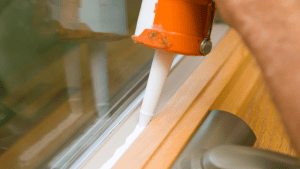 Apply silicone sealant or foam-based caulk around frames, paying attention to recessed areas that could accumulate water. Source: Canva
