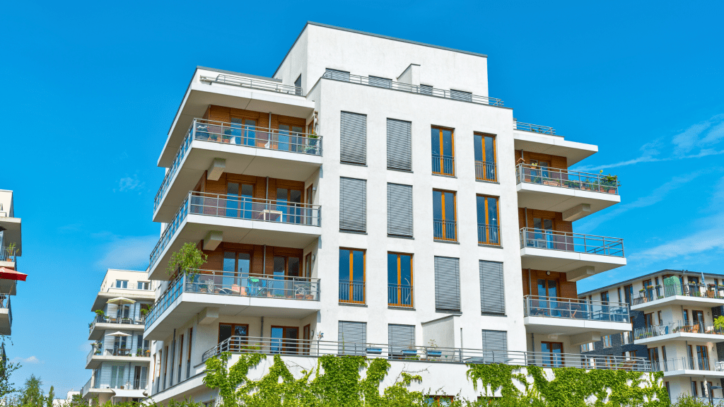 A modern apartment complex in a local neighbourhood (for reference only). Source: Canva