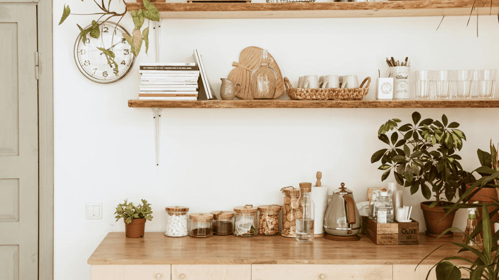 Wall-mounted hooks and floating shelves are inexpensive solutions that keep clutter off the floor. Source: Canva
